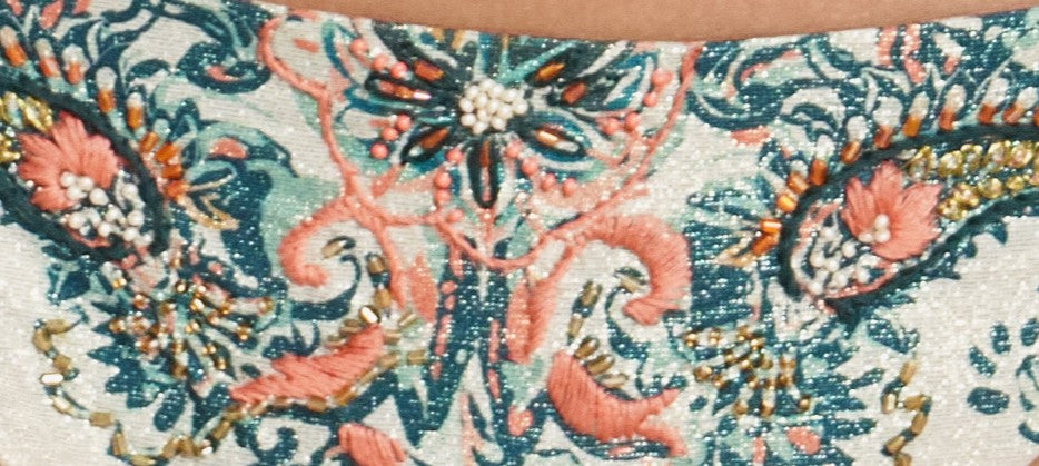 A close up look of the handmade embroidery of the Azure Tie Side Bikini Bottom (Cheeky).